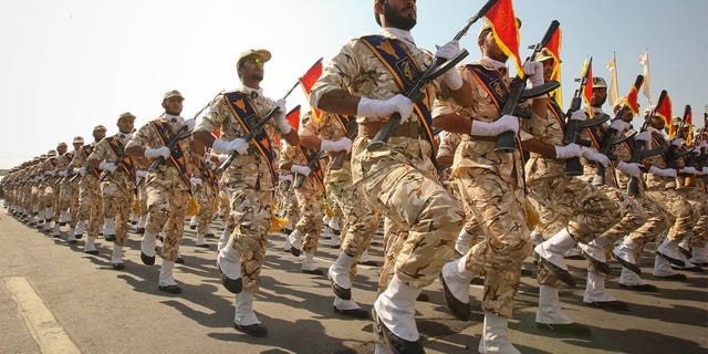 Members of the Iranian revolutionary guard march during a parade to commemorate the anniversary of the Iran-Iraq war.