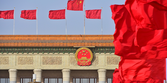 Flags fly in front of the Great Hall of the People on March 4, 2022, in Beijing.
