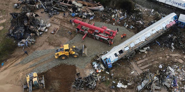 The wreckage of the trains lie next to the rail lines in Tempe, Greece, on March 3, 2023. 