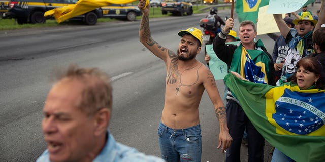 Supporters of former Brazilian President Jair Bolsonaro protest his reelection loss on the highway leading to Sao Paulo-Guarulhos International Airport in Guarulhos, Brazil, on Nov. 1, 2022.