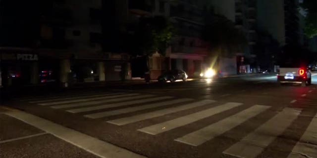 Vehicles are seen on a dark street after a grid fire caused massive blackouts in Argentina.