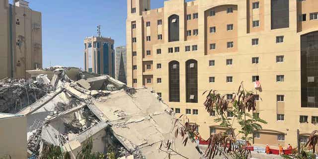 The ruins of a collapsed building are seen in Doha, Qatar, on March 22, 2023. At least one person has been confirmed dead following the collapse.