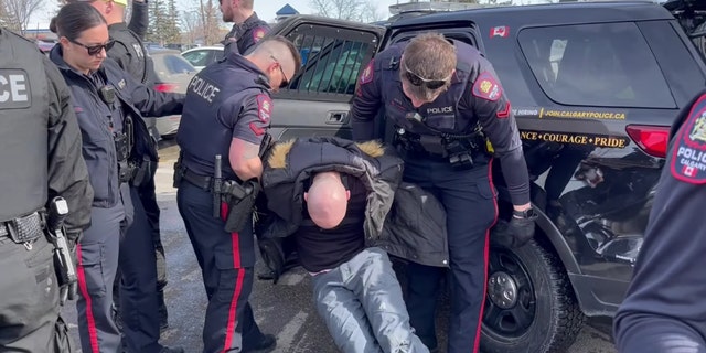 Pastor Derek Reimer, 36, was arrested and charged Wednesday with one count of breaching a release order that prohibited him from being within 200 meters of events involving the LGBTQ community.
