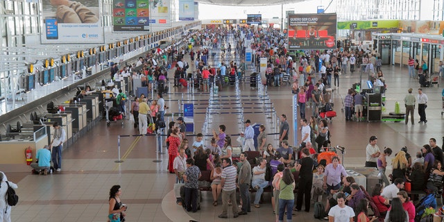 Travelers at Arturo Merino BenÍtez International Airport, where an attempted heist Wednesday left a security officer and an assailant dead.