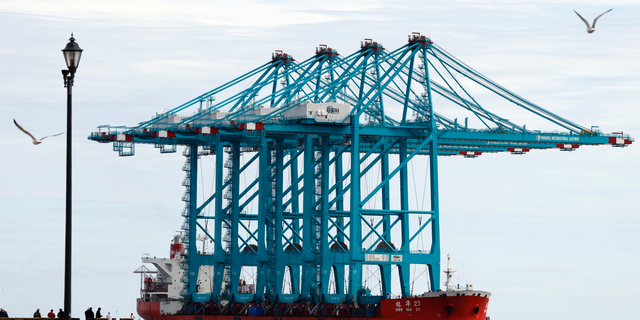 Spectators watch a Chinese ship carrying giant cranes approach the entrance to Hampton Roads in Virginia.