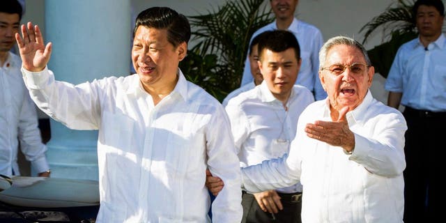 Cuba's President Raul Castro, right, stands next to Chinese President Xi Jinping, left, in Santiago de Cuba July 23, 2014. Xi ended an eight-day trip through Latin America on Wednesday with a visit to eastern Cuba, where both the island's independence struggle against Spain and Fidel Castro's revolution began.