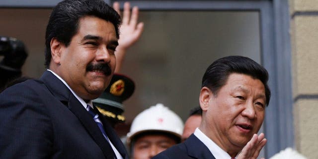 China will provide Venezuela with a $4 billion credit line under an agreement signed on Monday, with the money to be repaid by oil shipments from OPEC member Venezuela. The deal was inked during a 24-hour visit to Venezuela by Chinese President Xi Jinping, right, who is on a tour of Latin America.