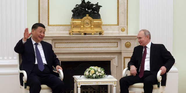 Russian President Vladimir Putin speaks with Chinese President Xi Jinping at the Kremlin on March 20, 2023. 