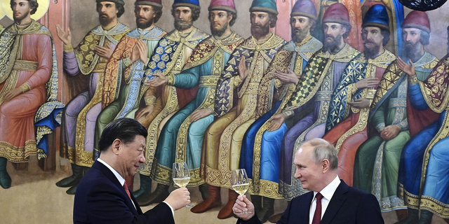 Russian President Vladimir Putin and Chinese President Xi Jinping toast during their dinner at The Palace of the Facets in Moscow, Russia, on March 21.