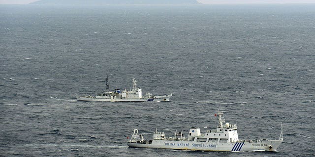 China Marine Surveillance ship, bottom, is followed by a Japan Coast Guard ship near disputed islands in the East China Sea on Nov. 15, 2012. 