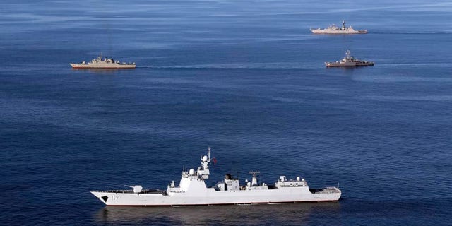In this file photo provided by the Iranian Army, warships sail in the Sea of Oman during the second day of joint Iran, Russia and China naval war games on Dec. 28 2019. 