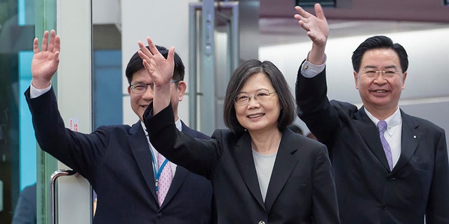 Taiwan's Presidential office secretary general Lin Chia-lung, left, President Tsai Ing-wen, center, and Foreign Minister Joseph Wu depart on an overseas trip at Taoyuan International Airport in Taipei, Taiwan, Wednesday, March 29, 2023. 