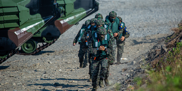 Soldiers disembark from AAV7 amphibious assault vehicles during the Han Kuang military exercise, which simulates China's People's Liberation Army (PLA) invading the island, on July 28, 2022 in Pingtung, Taiwan. Taiwan military launches five days of live fire drills involving all forces of the military to repel simulated attacks from China. (Photo by Annabelle Chih/Getty Images)