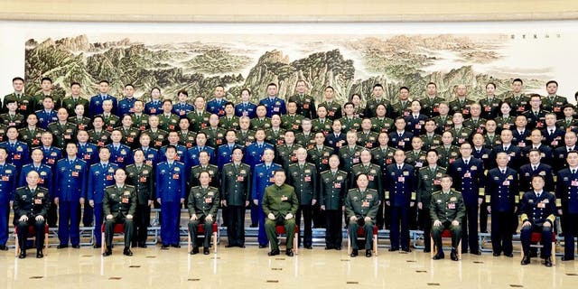 Chinese President Xi Jinping, also general secretary of the Communist Party of China Central Committee and chairman of the Central Military Commission, poses for a group photo with deputies from the delegation of the People's Liberation Army PLA and the People's Armed Police Force before attending a plenary meeting of the delegation during the first session of the 14th National People's Congress NPC in Beijing March 8, 2023.