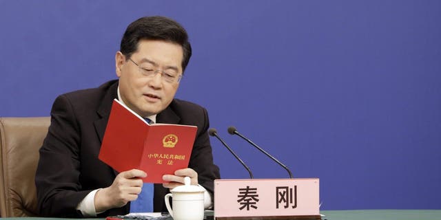 Qin Gang, China's foreign minister, speaks while holding a copy of the constitution during a news conference in Beijing, Tuesday, March 7, 2023.