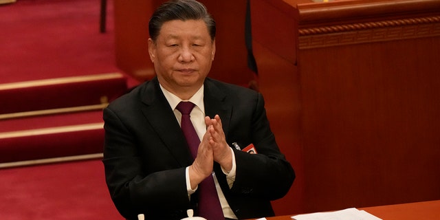 Chinese President Xi Jinping applauds during a session of China's National People's Congress (NPC) at the Great Hall of the People in Beijing, Friday, March 10, 2023. 