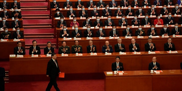 Chinese President Xi Jinping walks to cast his vote during a session of China's National People's Congress (NPC) to select state leaders at the Great Hall of the People in Beijing, Friday, March 10, 2023. 