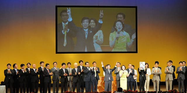 Ryuho Okawa, leader of religious corporation "Happy Science," waves to supporters during their west Tokyo meeting at Chofu City Green Hall on July 22, 2009 in Tokyo. Okawa announced his candidacy for the lower house election from The Happiness Realization Party.  