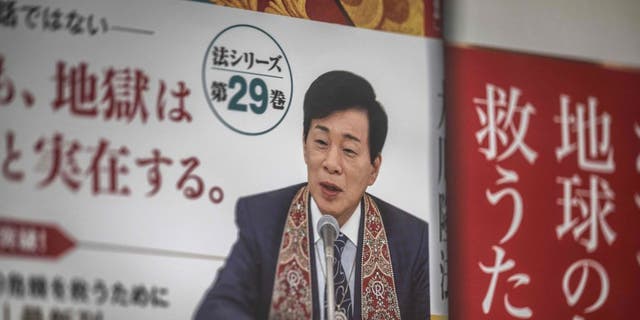 Ryuho Okawa, the leader of the Japanese "Happy Science" religious organization, is seen on an advertisement for his book in front of the spiritual movement's headquarters in Tokyo on March 2, 2023. Okawa died on March 2, 2023 aged 66, local media reported.