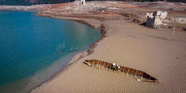 The Sau reservoir in Spain is pictured on March 20, 2023. The Sau reservoir's water levels now stand at nine percent of total capacity, so officials have taken the decision to remove its fish to prevent them from asphyxiating. 