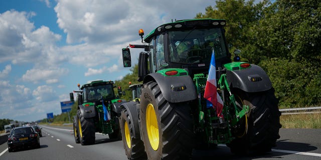 Demonstrating farmers slow down traffic on a motorway near Venlo, Netherlands, Monday, July 4, 2022. Dutch farmers angry at government plans to slash emissions used tractors and trucks Monday to blockade supermarket distribution centers, the latest actions in a summer of discontent in the country's lucrative agricultural sector. 