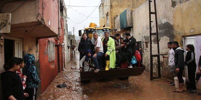People are rescued during floods after heavy rains in Sanliurfa, Turkey, on March 15, 2023. 