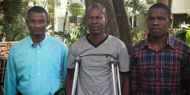 David Boniface, Nissage Martyr and Juders Yseme, from left, pose together in January 2014, in Haiti. Boniface, Yseme, and Martyr's son Nissandere are plaintiffs in a suit against former Les Irois, Haiti, Mayor Jean Morose Viliena, who is accused of terrorizing his political opponents. 