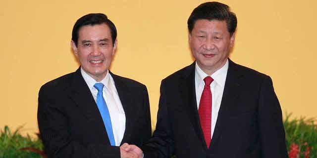 Taiwan's former President Ma Ying-jeou, left, and China's President Xi Jinping shake hands on Nov. 7, 2015, in Singapore. Former Taiwan President Ma will visit China next week to ease tension in the region.