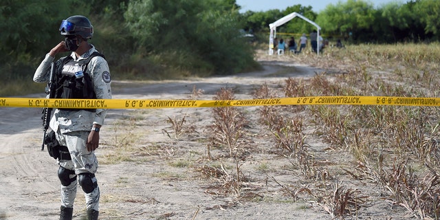 A member of the National Guard guards the entrance to a property called "La Bartolina" in the border city of Matamoros, Tamaulipas state, Mexico on August 23, 2021.