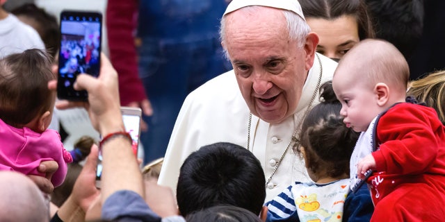Pope Francis greets and blesses the children, assisted by the Vatican's Santa Marta Pediatric Dispensary, at the Paul VI Hall in 2019.