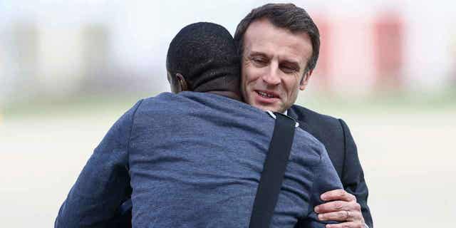 French President Emmanuel Macron, right, greets freed French journalist Olivier Dubois, who was held hostage in Mali for nearly two years, upon his arrival in Villacoublay, France, on March 21, 2023. 