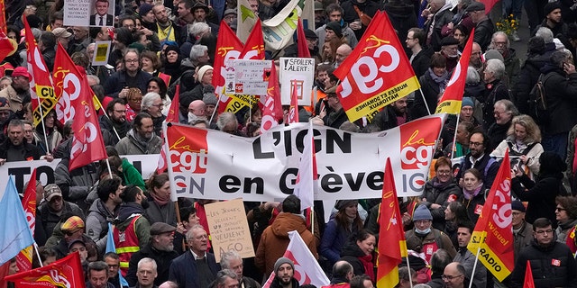 People march during a demonstration Tuesday, March 28, 2023, in Paris. 