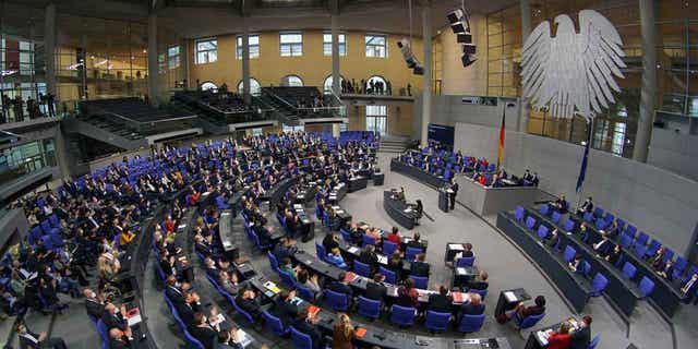 German Chancellor Olaf Scholz delivers a speech during a meeting of the Bundestag at the Reichstag building in Berlin, Germany, on Dec. 15, 2021. German lawmakers approved a reform of the country's voting system that would reduce the size of the parliament.