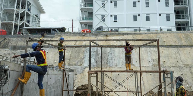Indonesia is planning to move its capital from Jakarta to the island of Borneo. Workers build a metal structure at the construction site of the new capital city in Indonesia, on March 8, 2023. 