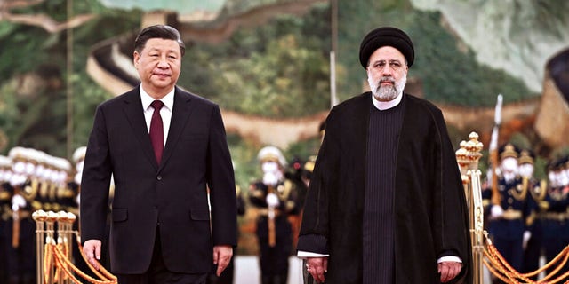 Iranian President Ebrahim Raisi walks with Chinese President Xi Jinping after reviewing an honor guard at the Great Hall of the People in Beijing, Feb. 14, 2023.