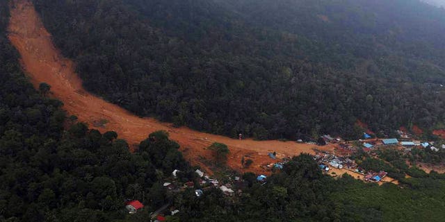 A landslide tears through a village on Serasan Island, Indonesia. Rescuers in the remote Indonesian island are searching for people who are believed to be buried in their houses.