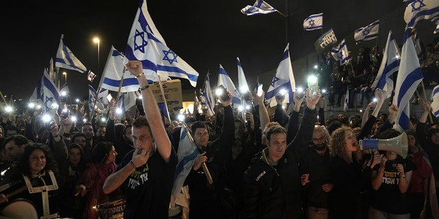 Israelis opposed to Prime Minister Benjamin Netanyahu's judicial overhaul plan protest outside of the Knesset, the country's parliament, after the Israeli leader fired his defense minister, in Jerusalem, Monday, March 27, 2023.