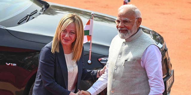 Italian Premier Giorgia Meloni, left, is received by Indian Prime Minister Narendra Modi at the Indian Presidential Palace in New Delhi on March 2, 2023. 