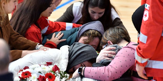 Relatives cry on the coffin of one of the victims of last Sunday's shipwreck in Crotone, Italy, on March 1, 2023. 