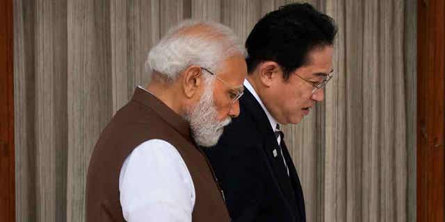 Japan's Prime Minister Fumio Kishida, right, and Indian Prime Minister Narendra Modi, talk before a meeting in New Delhi, India, on March 20, 2023. Kishida headed to Kyiv on March 21, 2023, to talk with Ukrainian President Volodymyr Zelenskyy.