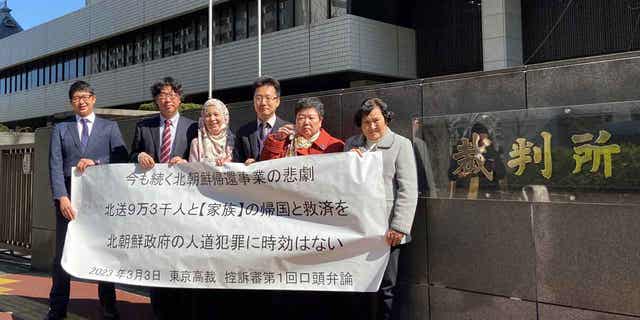 Two of five plaintiffs and supporters stand outside the Tokyo High Court, on March 3, 2023, after their first hearing in the appeals trial demanding North Korea pay damages over the repatriation program which they say was illegal solicitation and detainment.