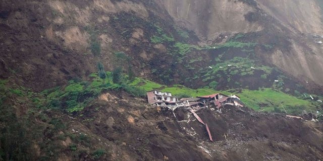Homes are destroyed after a deadly landslide caused by heavy rains that buried dozens of homes in Alausi, Ecuador, on March 27, 2023.