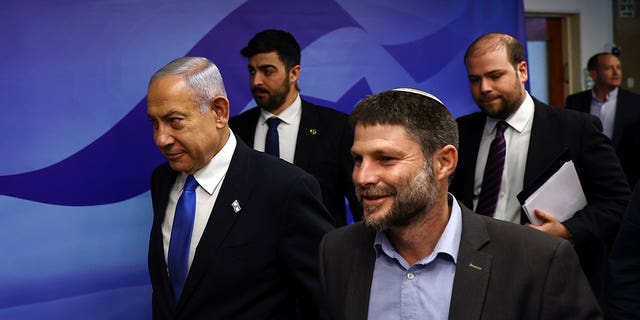 Israeli Prime Minister Benjamin Netanyahu, left, and Finance Minister Bezalel Smotrich, right, arrive to attend a cabinet meeting in Jerusalem on Feb. 23, 2023. Smotrich said there's no such thing as a Palestinian people.