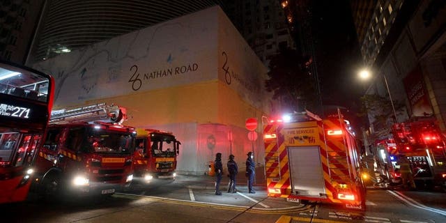 Firefighters respond to a fire breaking out in an office building in Tsim Sha Tsui, in Hong Kong on early March 3, 2023. 