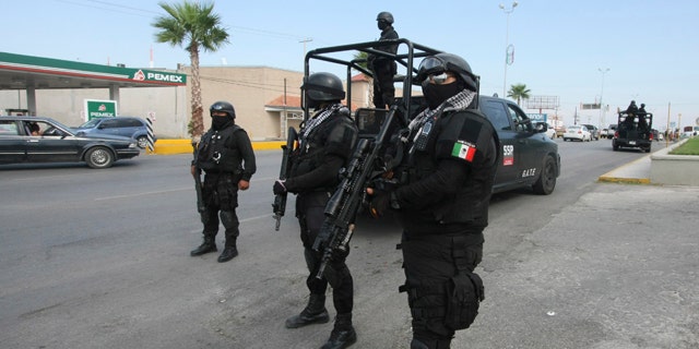 Rapid response Coahuila state police stand at a checkpoint in the city of Piedras Negras, Mexico.