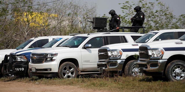 Police officers keep watch at the scene where authorities found the bodies of two of four Americans kidnapped by gunmen in Matamoros, Mexico, March 7, 2023.