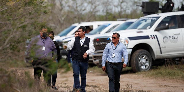 Tamaulipas attorney general's office personnel walk where authorities found the bodies of two of four Americans kidnapped by gunmen in Matamoros, Mexico, March 7, 2023.