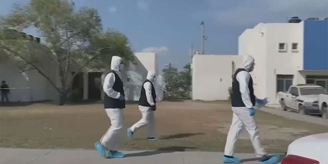 Medical professionals walking on a street in Mexico.