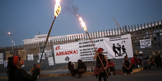 Activists protest outside a migrant detention center in Ciudad Juarez, Mexico, March 29, 2023, a day after dozens of migrants died in a fire at the center. 