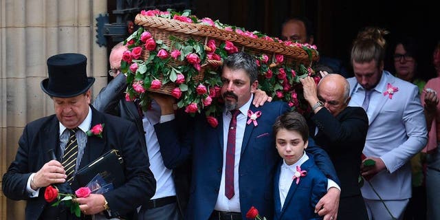 Pallbearers, including the father of Manchester Arena Bombing victim Saffie-Rose Roussos, 8, Andrew and Saffie's brother Alexander, carry her coffin out of the church following Saffie's funeral service at Manchester Cathedral in Manchester, northwest England, on July 26, 2017.